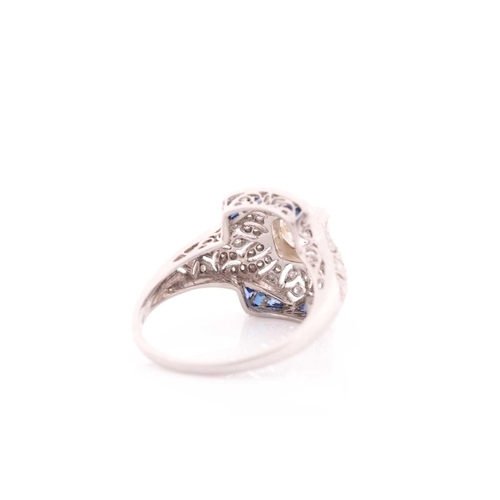 306 - An unusual diamond and sapphire ring, in the Art Deco style, centred with an old cushion-cut diamond... 