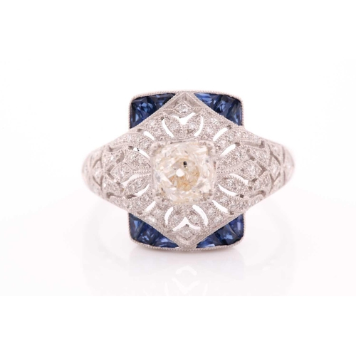 306 - An unusual diamond and sapphire ring, in the Art Deco style, centred with an old cushion-cut diamond... 