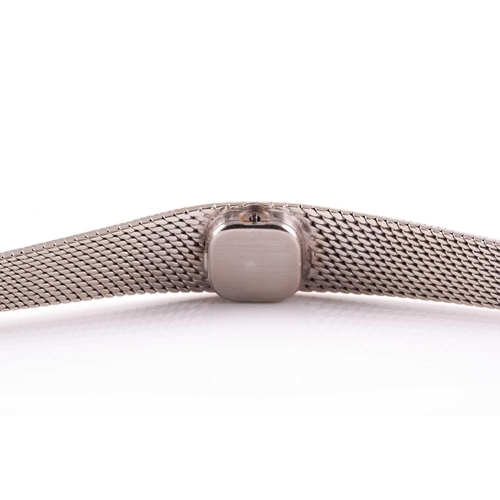 307 - An 18ct white gold ladies Omega cocktail watch, the small baton dial inset into an articulated strap... 