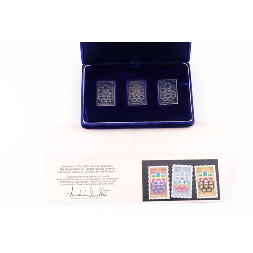 324 - A cased set of three silver ingots, designed as stamps, in honour of the 1976 Summer Olympics, relea... 