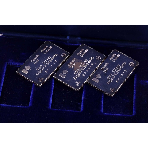 324 - A cased set of three silver ingots, designed as stamps, in honour of the 1976 Summer Olympics, relea... 