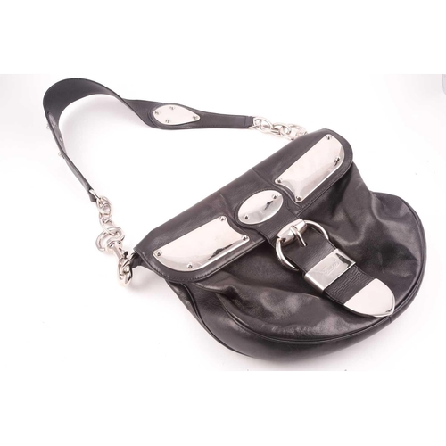 327 - Gucci. A black leather handbag, with chrome fittings and wide shoulder strap, paisley material lied ... 