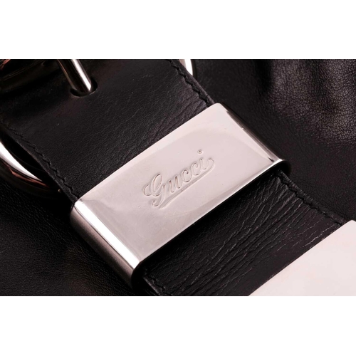 327 - Gucci. A black leather handbag, with chrome fittings and wide shoulder strap, paisley material lied ... 