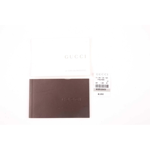 327 - Gucci. A black leather handbag, with chrome fittings and wide shoulder strap, paisley material lied ... 