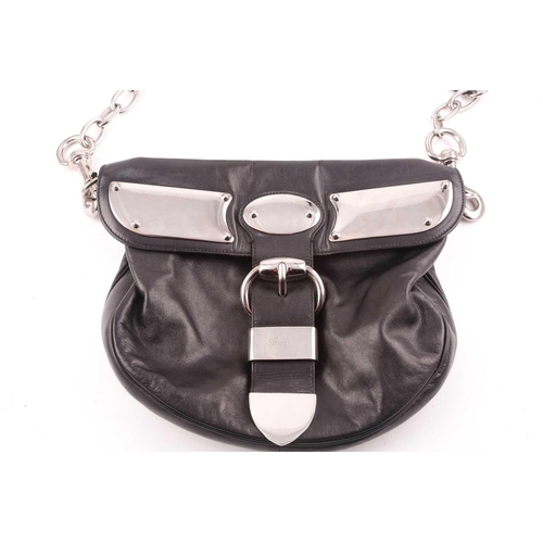 327 - Gucci. A black leather handbag, with chrome fittings and wide shoulder strap, paisley material lied ... 