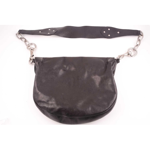 327 - Gucci. A black leather handbag, with chrome fittings and wide shoulder strap, paisley material lied ... 