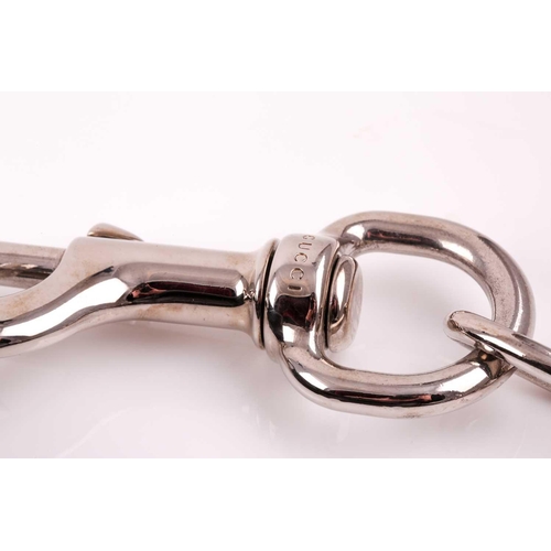 327 - Gucci. A black leather handbag, with chrome fittings and wide shoulder strap, paisley material lied ... 