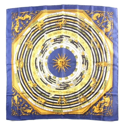 331 - Hermes, Paris. A polychrome zodiac scarf, with dark blue border, together with a Hermes scarf with t... 