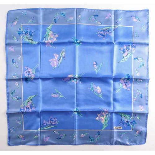 332 - A Liberty silk square scarf with peacock feathers on a black ground with a rust border, together wit... 