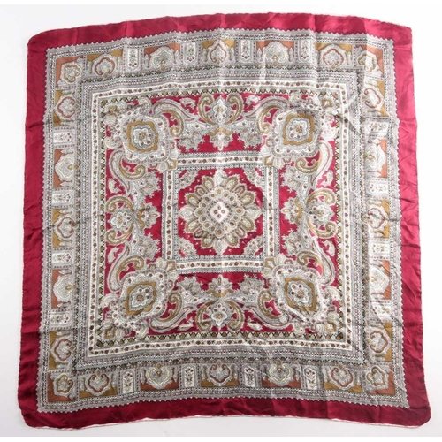 332 - A Liberty silk square scarf with peacock feathers on a black ground with a rust border, together wit... 