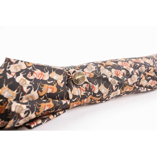 340 - A Ferragamo silk umbrella printed with horses on a black ground, with leather handle.