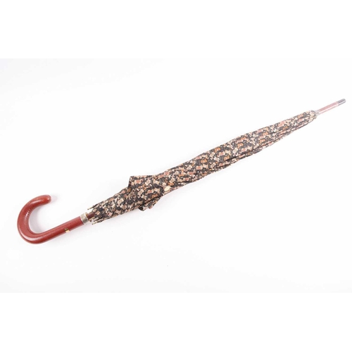 340 - A Ferragamo silk umbrella printed with horses on a black ground, with leather handle.