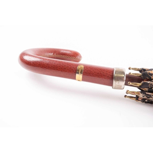 340 - A Ferragamo silk umbrella printed with horses on a black ground, with leather handle.