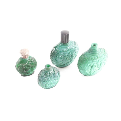 342 - A collection of four carved and moulded green glass scent bottles; carved with scenes from rural lif... 