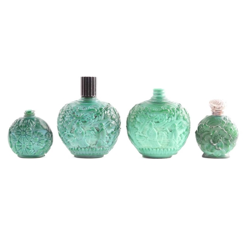 342 - A collection of four carved and moulded green glass scent bottles; carved with scenes from rural lif... 