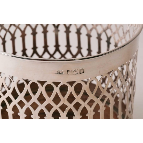 348 - A silver bottle holder. London 1908 by Mappin and Webb. Cylindrical with pierced sides and turned wo... 