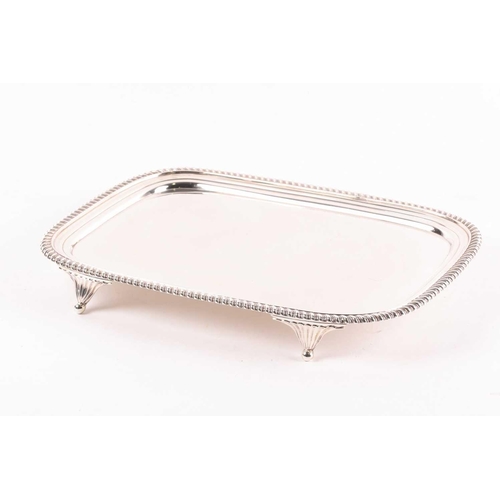 349 - A George III rectangular silver salver. London 1812 William Bennet, with raised gadrooned border on ... 