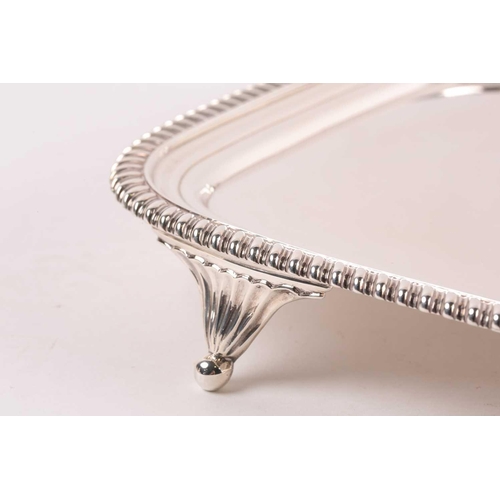349 - A George III rectangular silver salver. London 1812 William Bennet, with raised gadrooned border on ... 