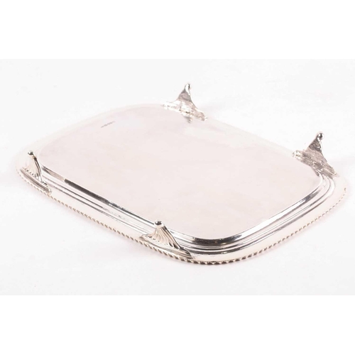 349 - A George III rectangular silver salver. London 1812 William Bennet, with raised gadrooned border on ... 