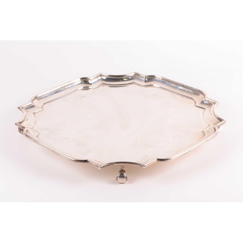 352 - A George V silver salver, London 1920 by Z Barraclough & Sons, of shaped, square form on four scroll... 