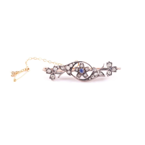 61 - A late 19th / early 20th century yellow metal floral bar brooch, inset with old-cut diamonds and cen... 