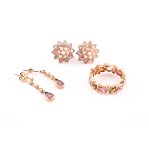 63 - A yellow metal, tourmaline, and diamond eternity ring, set with mixed pear-cut multi-coloured tourma... 