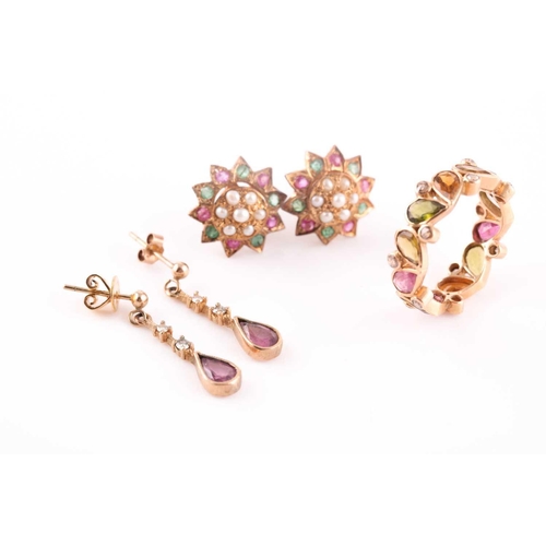 63 - A yellow metal, tourmaline, and diamond eternity ring, set with mixed pear-cut multi-coloured tourma... 