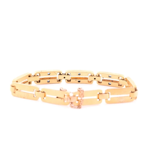 66 - A yellow metal, diamond and sapphire bracelet, comprised of articulated bar links, the three cenral ... 