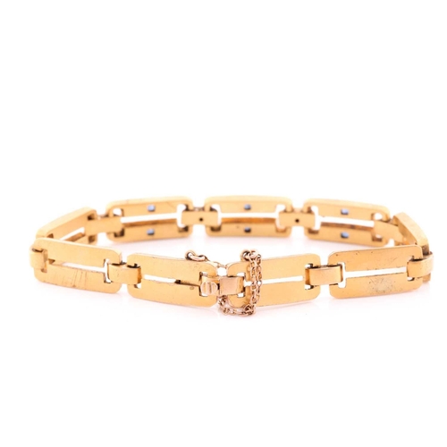 66 - A yellow metal, diamond and sapphire bracelet, comprised of articulated bar links, the three cenral ... 