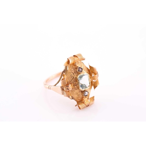 68 - A late 19th century yellow metal and aquamarine ring, the ornate rectangular mount with scrolled dec... 