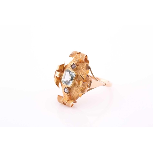 68 - A late 19th century yellow metal and aquamarine ring, the ornate rectangular mount with scrolled dec... 