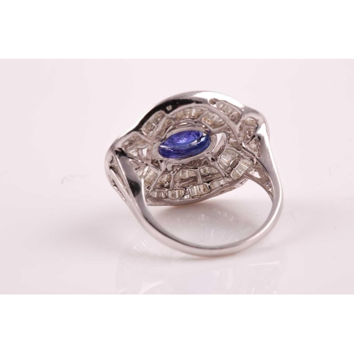 74 - A silver, diamond, and tanzanite ring, set east to west with a mixed oval-cut tanzanite of approxima... 