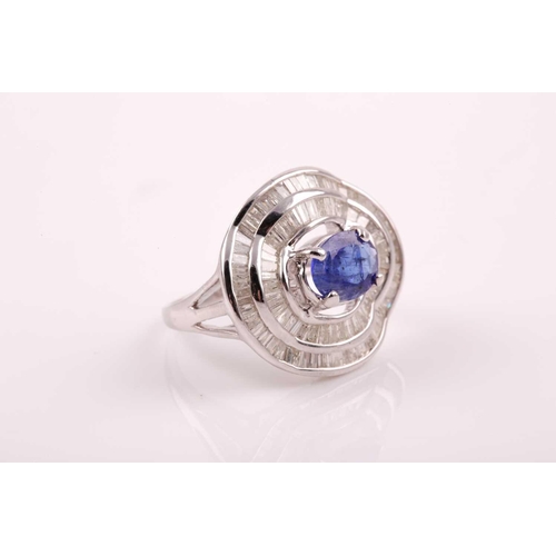 74 - A silver, diamond, and tanzanite ring, set east to west with a mixed oval-cut tanzanite of approxima... 