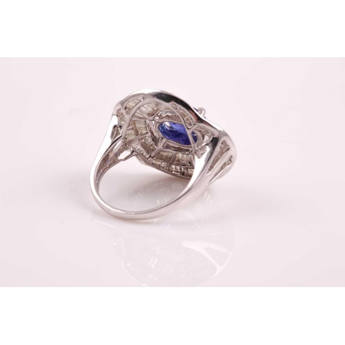 74 - A silver, diamond, and tanzanite ring, set east to west with a mixed oval-cut tanzanite of approxima... 