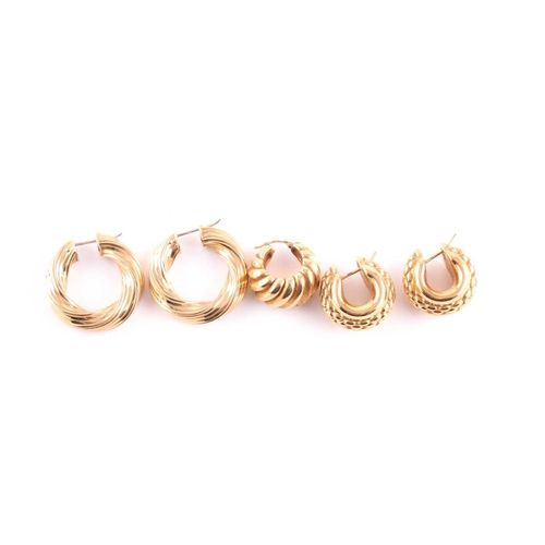 75 - A pair of yellow metal rope-twist hollow earrings, marked 750, 3.2 cm long, together with a pair of ... 