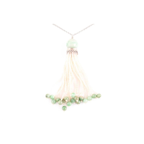81 - An Art Deco jade and seed pearl tassel pendant necklace, set with a rounded jade bead suspended with... 