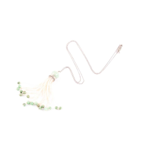 81 - An Art Deco jade and seed pearl tassel pendant necklace, set with a rounded jade bead suspended with... 