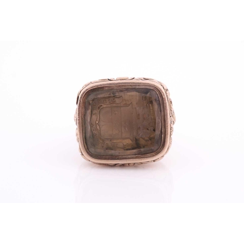 88 - A yellow metal and citrine quartz fob pendant, the intaglio engraving bearing a motto and coat-of-ar... 