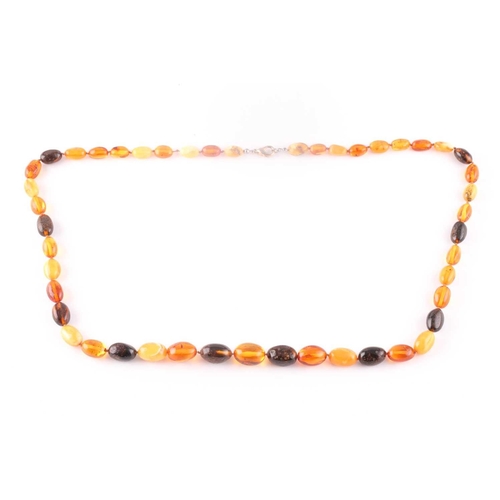 96 - An amber bead necklace, comprising of butterscotch and dark and light amber beads, largest approxima... 