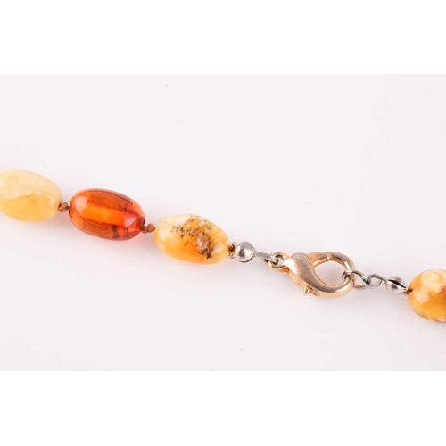 96 - An amber bead necklace, comprising of butterscotch and dark and light amber beads, largest approxima... 