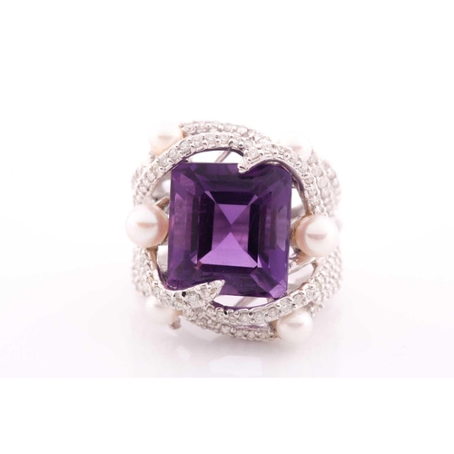 99 - An impressive diamond and amethyst cocktail ring, centred with a mixed square-cut amethyst, mounted ... 