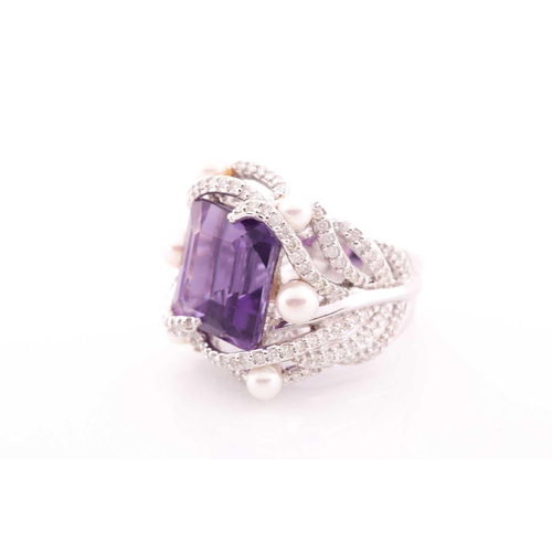 99 - An impressive diamond and amethyst cocktail ring, centred with a mixed square-cut amethyst, mounted ... 