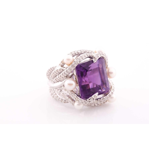 99 - An impressive diamond and amethyst cocktail ring, centred with a mixed square-cut amethyst, mounted ... 
