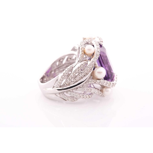 99 - An impressive diamond and amethyst cocktail ring, centred with a mixed square-cut amethyst, mounted ... 