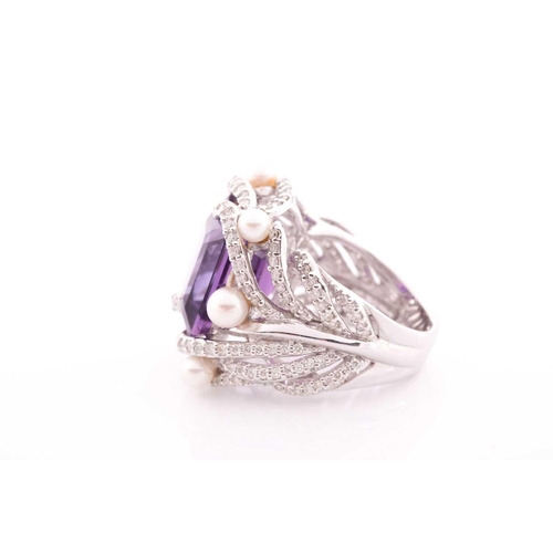 99 - An impressive diamond and amethyst cocktail ring, centred with a mixed square-cut amethyst, mounted ... 