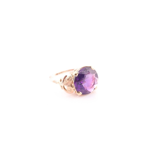 102 - A Continental yellow metal and round amethyst single stone ring, the round mixed-cut stone approxima... 