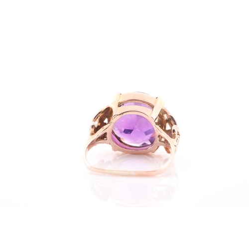 102 - A Continental yellow metal and round amethyst single stone ring, the round mixed-cut stone approxima... 