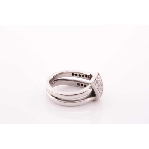 105 - An unusual white metal and diamond ring, of folded knot design, inset with round brilliant-cut diamo... 