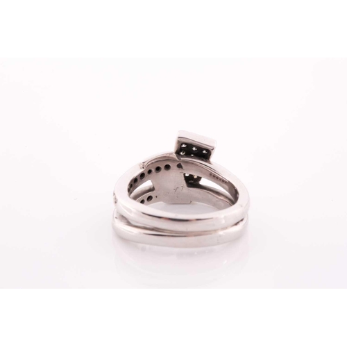 105 - An unusual white metal and diamond ring, of folded knot design, inset with round brilliant-cut diamo... 