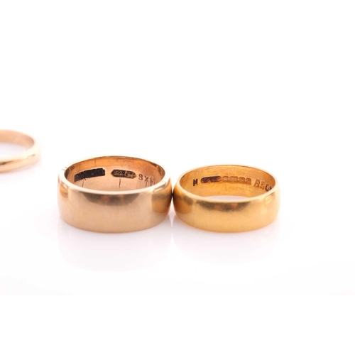 115 - A 22 carat gold wedding band, another 22 carat gold wedding band, 8.5 grams; a wide 9 carat gold wed... 
